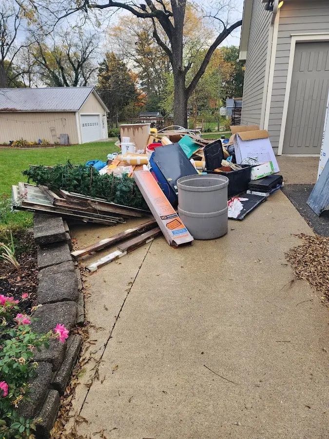 Dumpster being loaded with debris for 12 Yard Dumpster Rental in Oak Hill